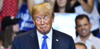 Donald Trump with eyes closed and pursed lips at an event