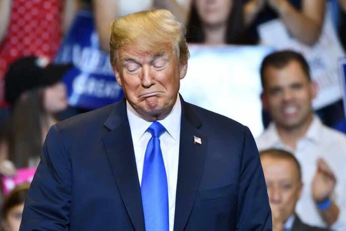 Donald Trump with eyes closed and pursed lips at an event
