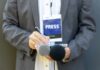 Journalist holding notebook and microphones