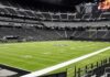 American football stadium interior with empty field and stands