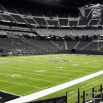 American football stadium interior with empty field and stands