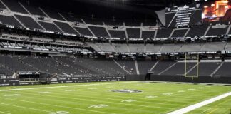 American football stadium interior with empty field and stands