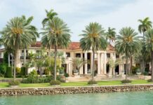 Two Television Stars Gather An Extraordinary Guest List Waterfront mansion with palm trees and grand columns