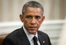 Obama Ignites Early-Vote Machine Man in suit looking to the side, identified as Rob Nabors