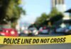 police tape blocking a blurred city street