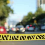 police tape blocking a blurred city street