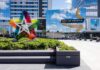 Mall entrance with colorful star sculpture and mirrored facade