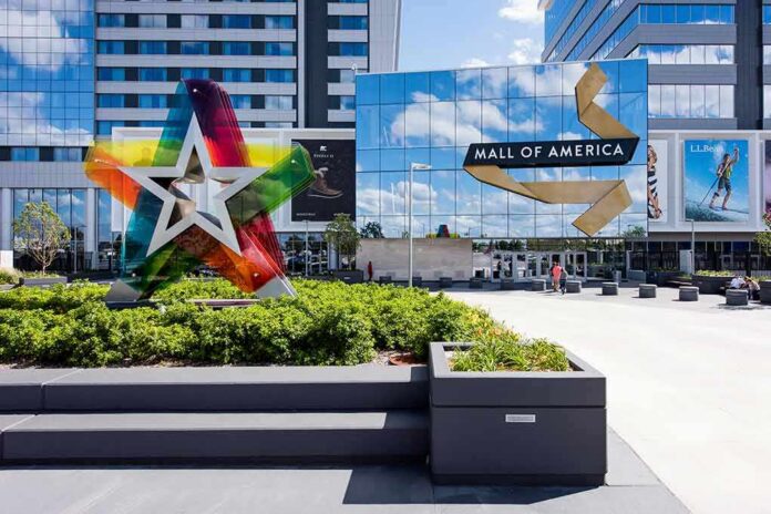 Mall entrance with colorful star sculpture and mirrored facade