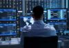A Digital Army Is Quietly Taking Shape IT professional monitors multiple screens in a server room