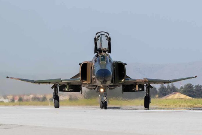 shutterstock_673984819-1 Military jet taxiing on runway with open canopy